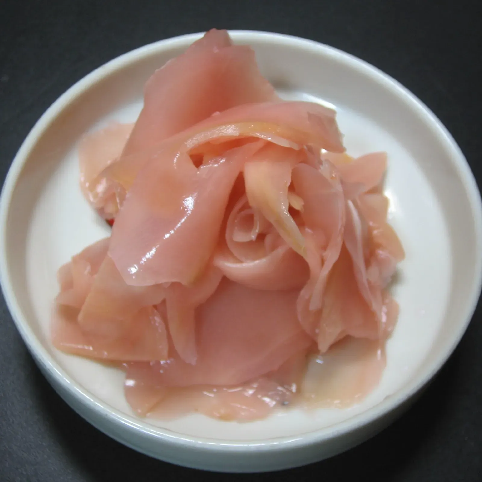 Pale pink gari in a small white bowl