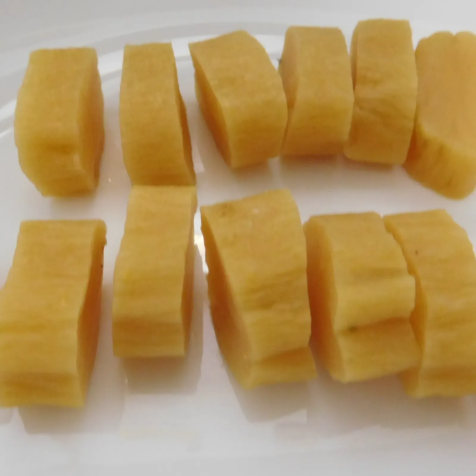 Sliced yellow takuan on a white plate